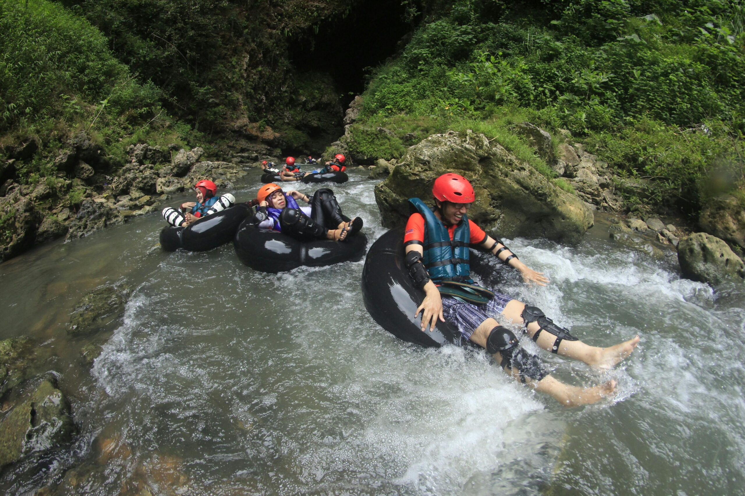 Kids need adventure group rafting adventure down rushing water.