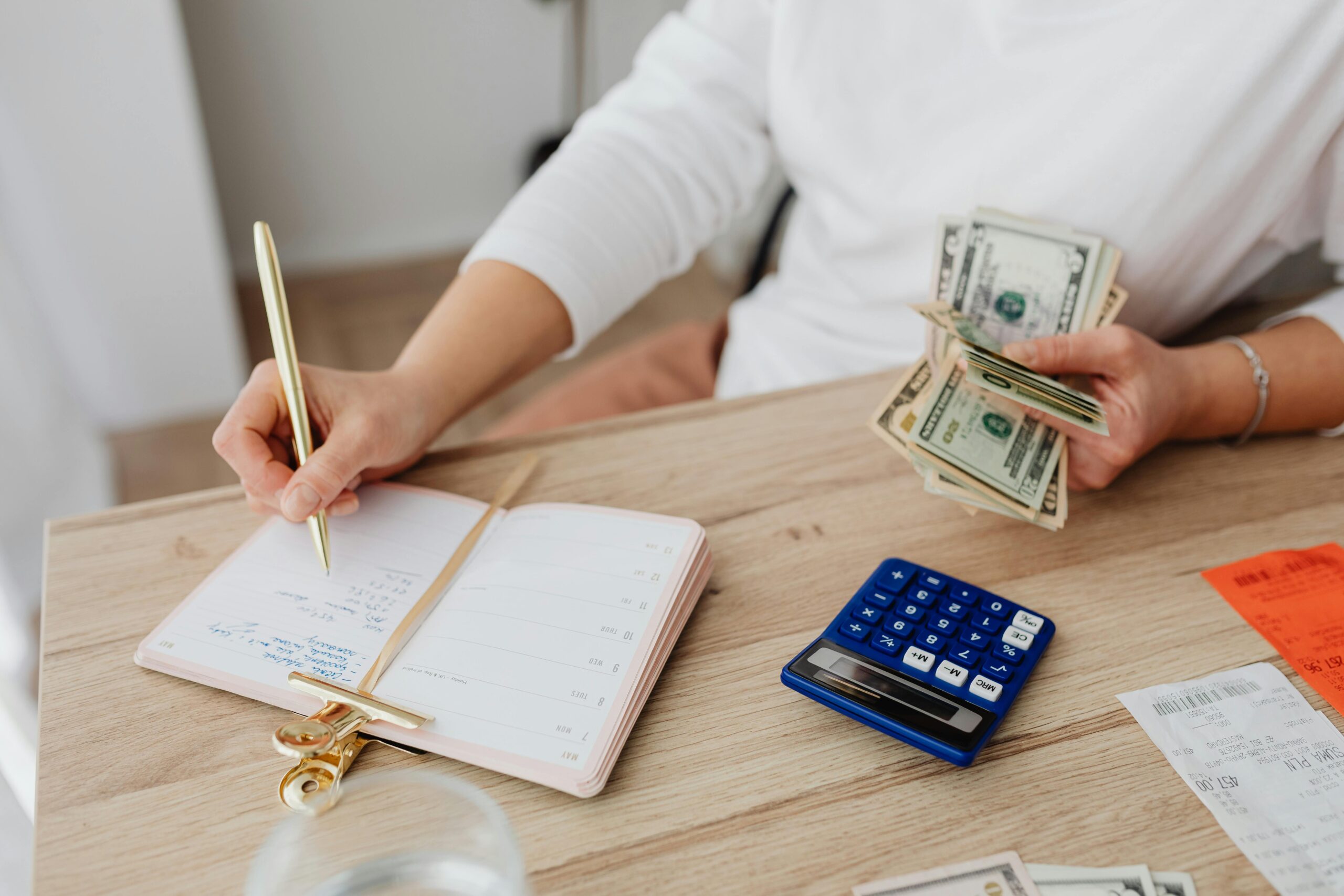 Thrifty Homeschooling mom calculates her purchases while holding money.